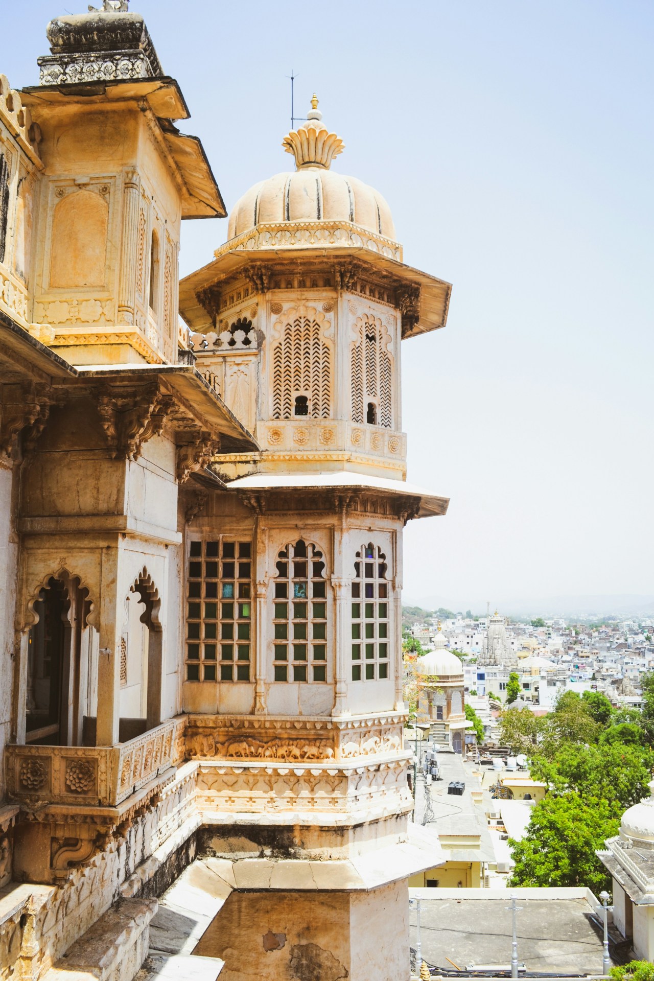 A guide and traveler walking a quiet path through the Aravalli hills of Rajasthan at golden hour